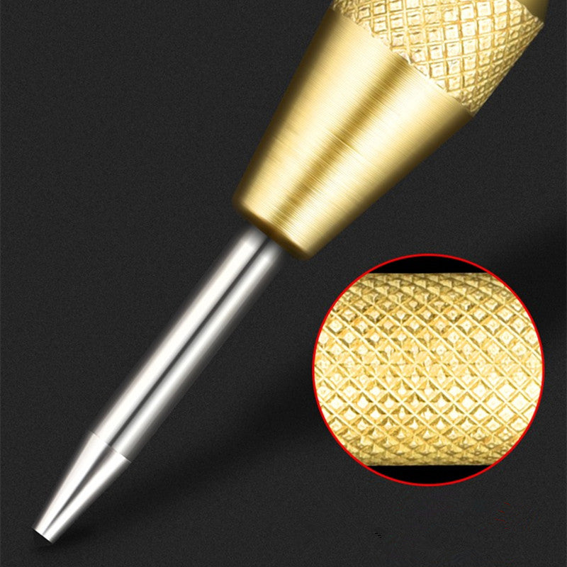 Spring-loaded center punch punching a starter mark in metal